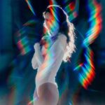 Aura vortex lens filters camera accesories RainbowBurst. Fashion model surrounded by light beams using Blast Filter