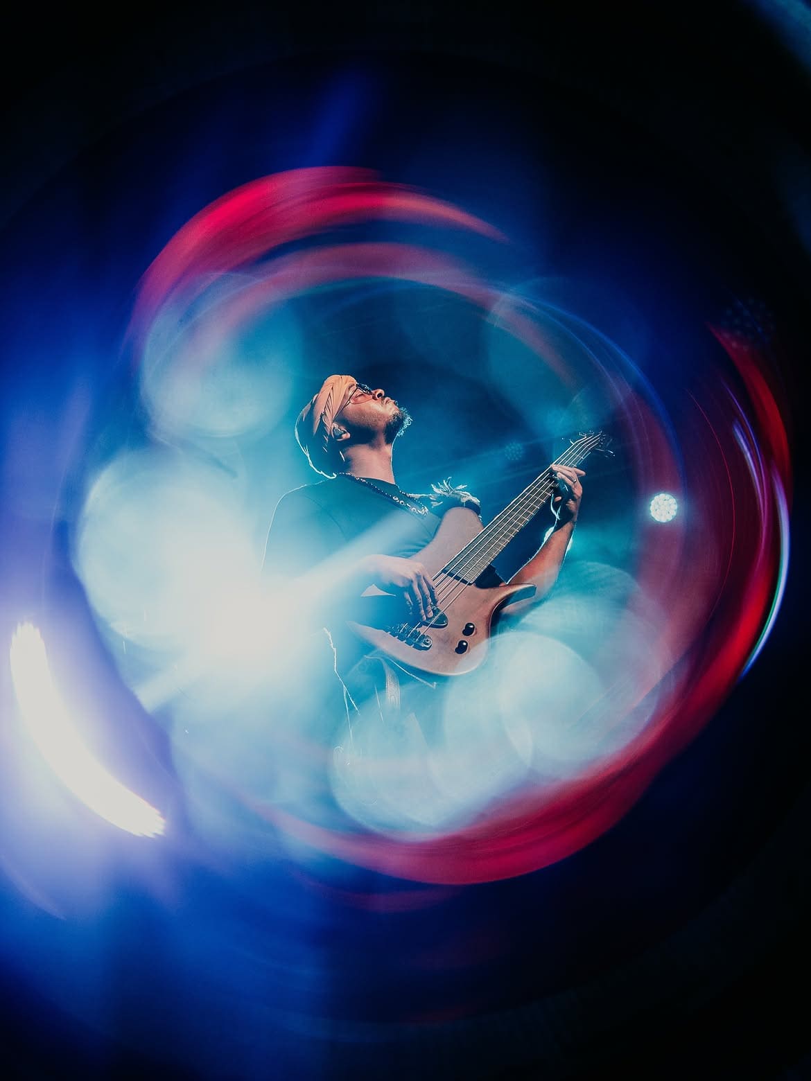 Musician performing live with SZ Filters Aura Filter creating colorful circular light effects