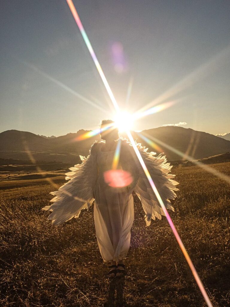 Winged portrait with direct sunlight and colorful lens flare showing light as part of the image