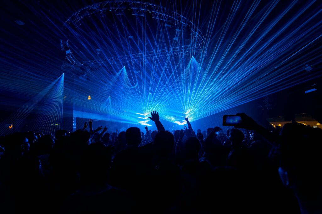 Blue laser beams over a crowd at a live concert