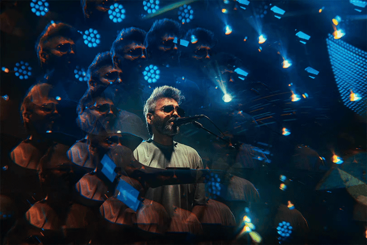 Concert loop showing a performer surrounded by repeated blue stage lights.