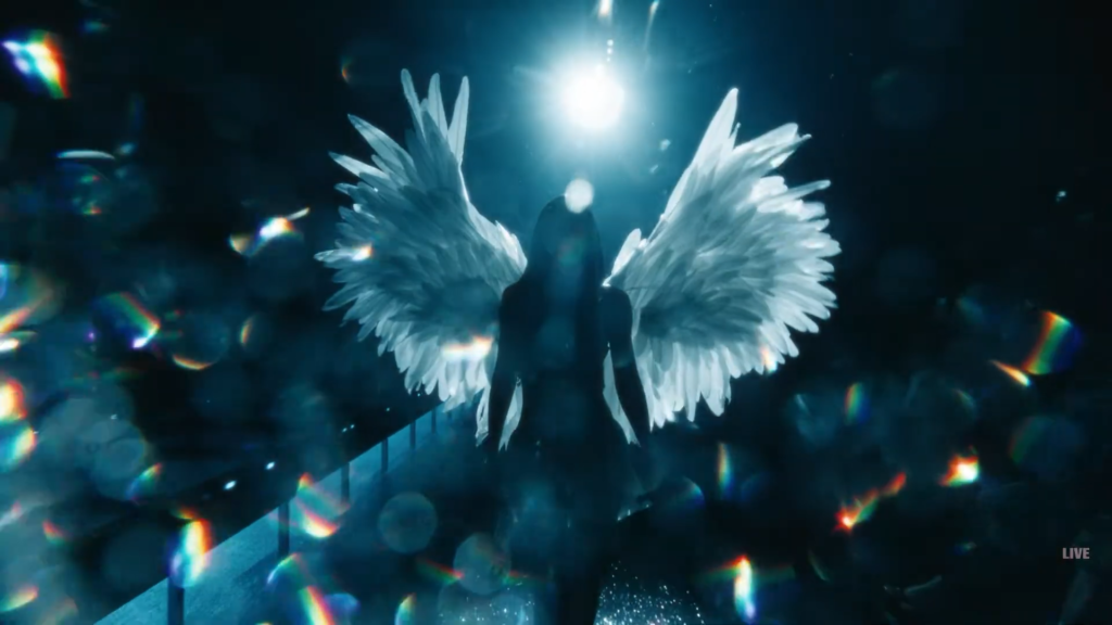 Kylie Jenner’s winged entrance at the Victoria’s Secret Fashion Show, surrounded by colorful prism reflections from The Gem by SZ Filters.